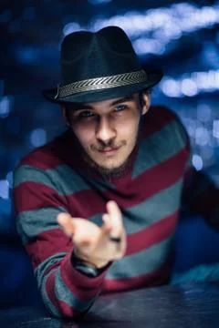 Portrait of a guy in a hat on a blurred background Stock Photos