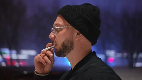 Portrait of a guy pulling a cigarette. Winter. Evening Video stock 147978899