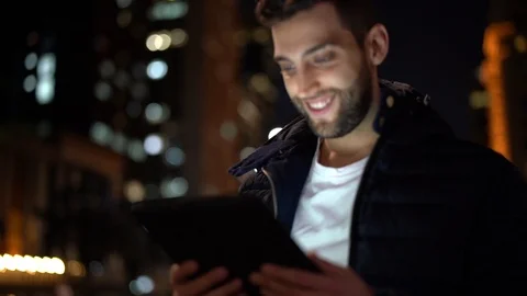 Portrait of a Guy using tablet at night Stock Footage 89729402