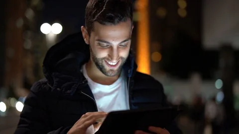 Portrait of a Guy using tablet at night Stock Footage 89729541