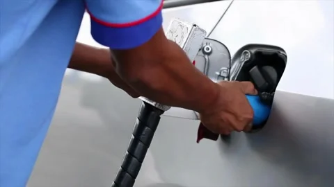 Portrait of a guy who refuels a gray convertible. Happy car ride, gas station Video stock 256721854