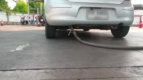 Portrait of a guy who refuels a gray convertible. Happy car ride, gas station Stock Footage 256721960