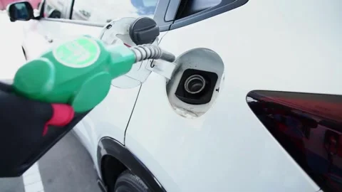 Portrait of a guy who refuels a gray convertible. Happy car ride, gas station 库存影片 336569618