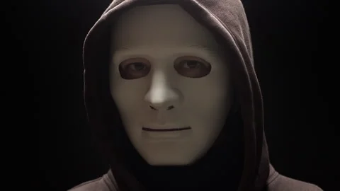Portrait of a hacker, anonymous masked face in a dark room. Mystical personality Stock Footage 303913077