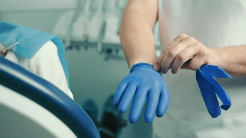 Portrait of hands of dentist wearing blue gloves before procedure Stock Footage
