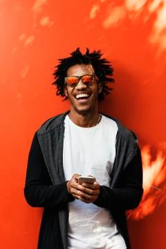Portrait of handsome afro man using his mobile. Stock Photos