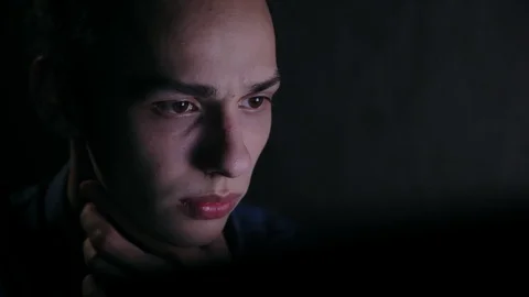 Portrait of handsome and concentrated computer user at night, close up Video stock 99932317