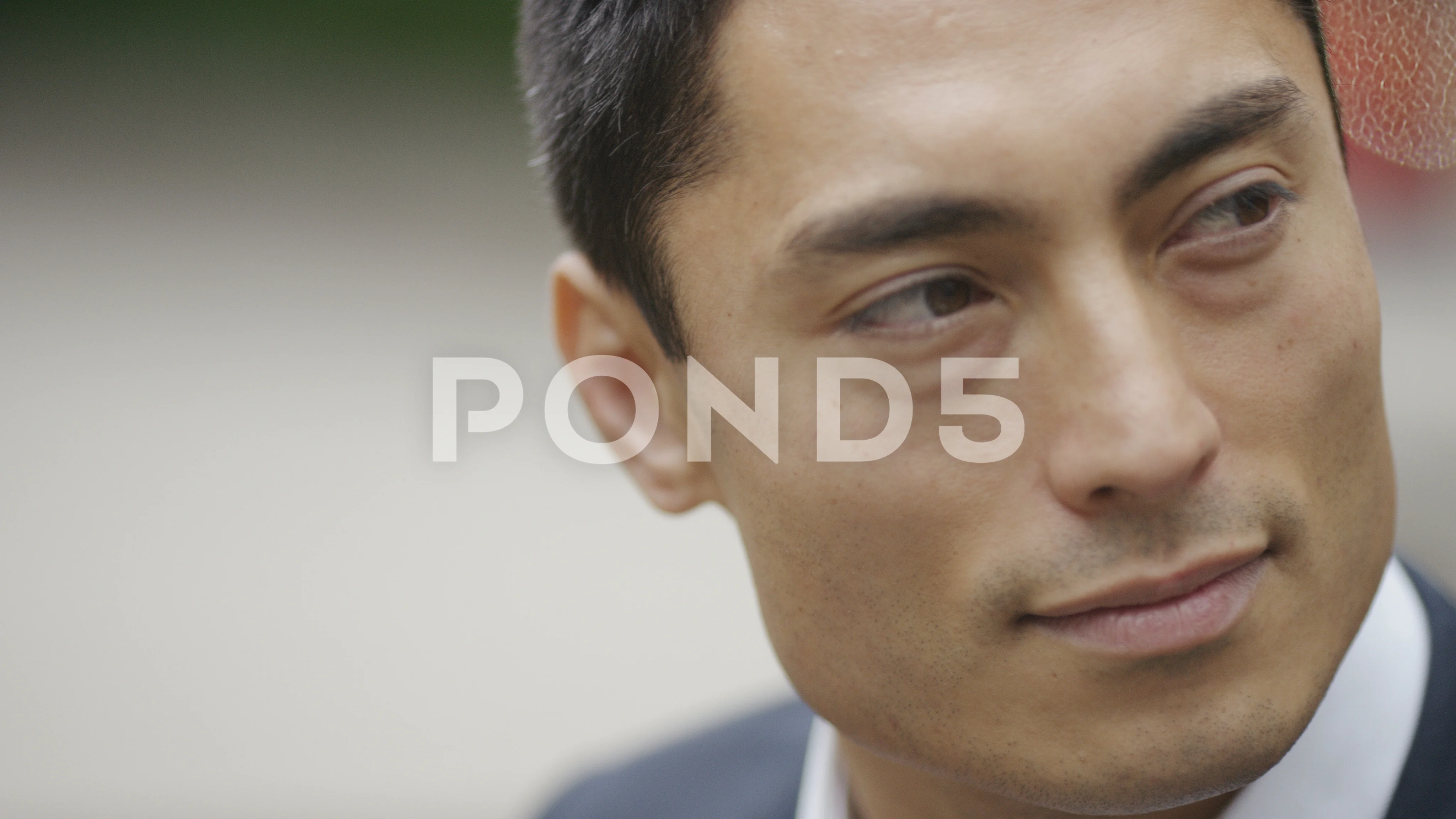 Portrait of handsome asian man looking around, in slow motion