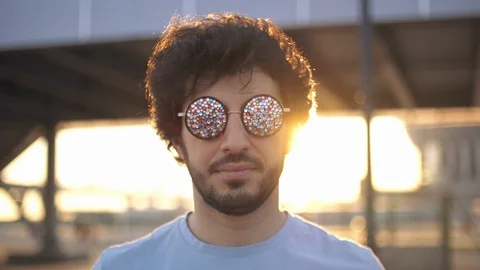 Portrait of Handsome attractive eastern man take off cool sunglasses at sunset Stock Footage 109458636