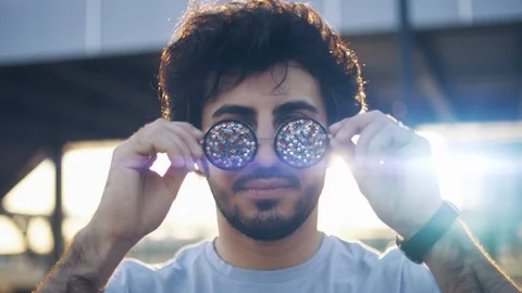 Portrait of Handsome attractive eastern man take of cool sunglasses at sunset Stock Footage 109458679