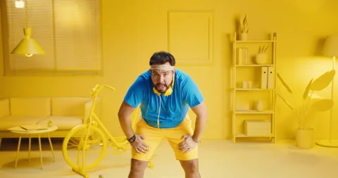 Portrait of a handsome bearded young man working out while wearing headphones Stock Footage 165865357