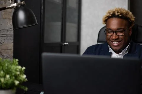 Portrait of a handsome black guy using a laptop Stock Photos