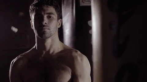 Portrait of handsome boxer gets ready to box looking at the camera. Видео 76917088