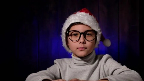 Portrait of handsome boy in red hat and glasses with a sparkler in his hand. Stock Footage 166171755
