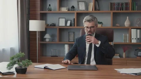 Portrait of handsome businessman open using a laptop drinking coffee looking Vídeos de archivo 220153758