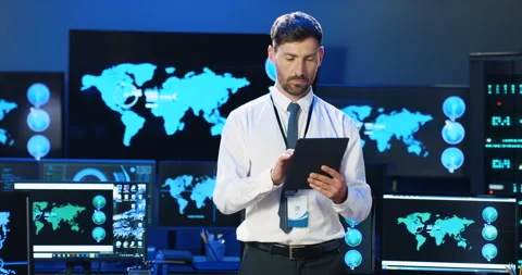 Portrait of handsome Caucasian man using tablet device and looking at camera in Stock Footage 137147176