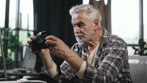 Portrait of handsome gray haired senior man photographer hold digital camera Stock Footage 253513260