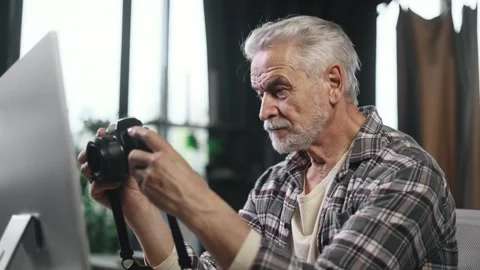 Portrait of handsome gray haired senior man photographer hold digital camera Stock Footage 253513630