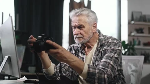 Portrait of handsome gray haired senior man photographer hold digital camera Stock Footage 253513645