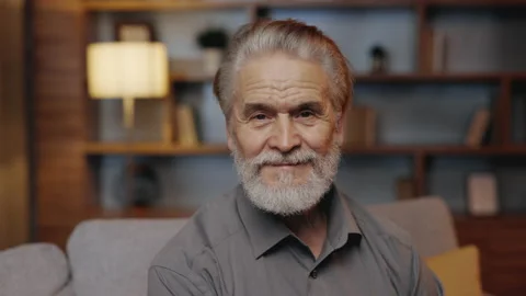 Portrait of the handsome grey haired smiled mature caucasian man sitting on the Stock Footage 231749219