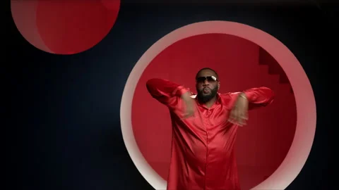 Portrait of a handsome guy dancing on a red background in a good mood. The Video stock 144568688