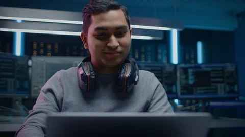 Portrait of Handsome Indian Software Developer / Hacker / Programmer Sitting Stock Footage 103578496