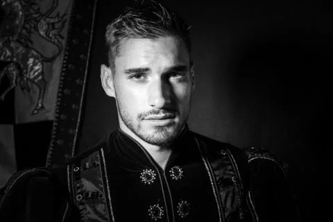Portrait of handsome king with beard dressed in costume looking at camera Stock Photos