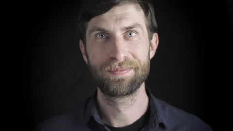 Portrait of a handsome man with a beard. Smiling at the camera, serious facial Video stock 139817272