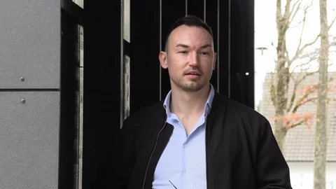 Portrait of a handsome man in a black jacket, closeup Stock Footage 126556580