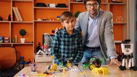 Portrait of the handsome man with a boy looking into the camera surrounded by Stock Footage 82476058