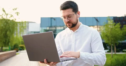 Portrait of handsome man copywriter using laptop computer, typing, working freel Stock Footage 316301639