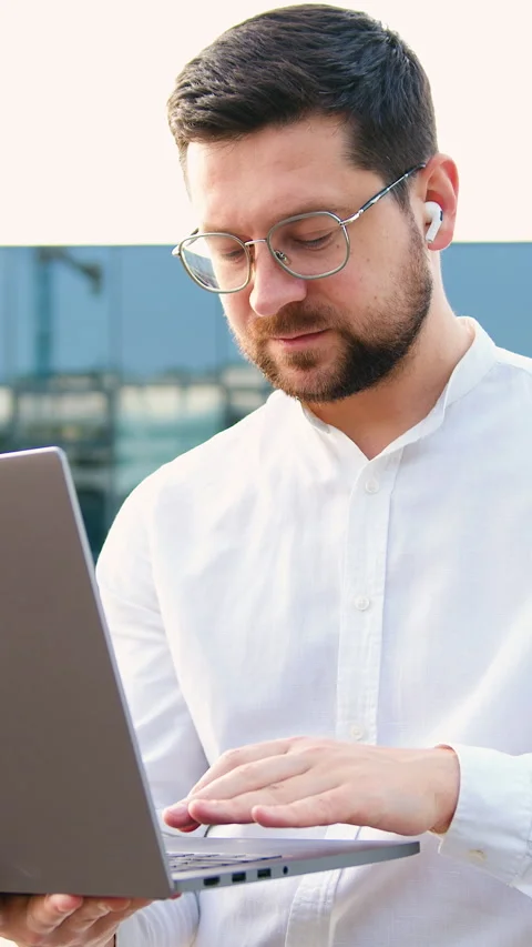 Portrait of handsome man copywriter using laptop computer, typing, working freel Stock Footage 327546967