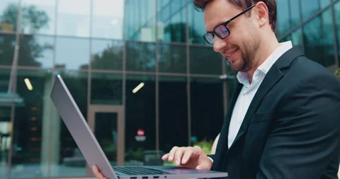 Portrait of handsome man copywriter using laptop computer, typing, working Stock Footage 347675746