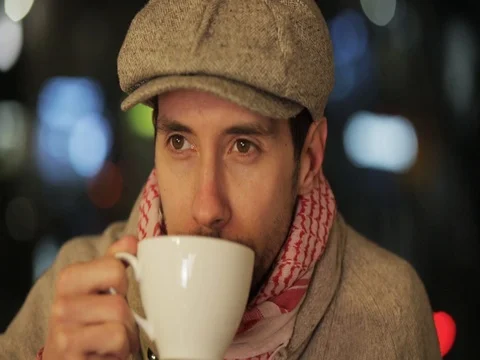 Portrait of a handsome man drinking coffee on the street Video stock 72546697
