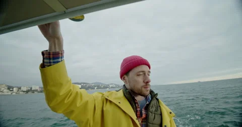 Portrait of handsome man floats on the ship and looks around. Ocean fishing. Stock Footage 199827976