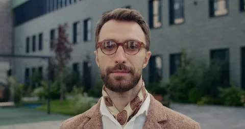 Portrait of handsome man in glasses with beard looking to camera. Close up of Stock Footage 145121815