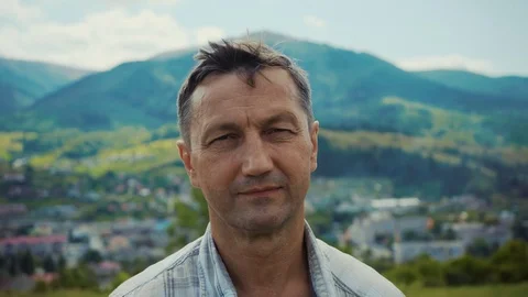 Portrait of handsome man look at camera background mountains summer elderly face Stock Footage 116997208