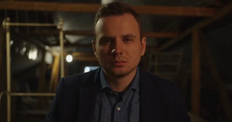 Portrait of handsome man looking at the camera in  dark area room , cinematic mo Stock Footage 118826856