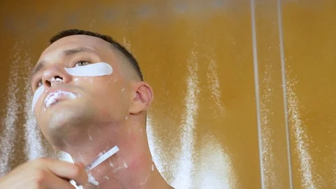 Portrait of a handsome man with a mask under the lower eyelid, which is shaved Stock Footage 109119755