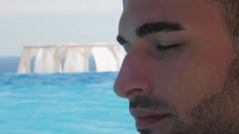 Portrait of a handsome man in the pool, Close up Stock Footage 145080535
