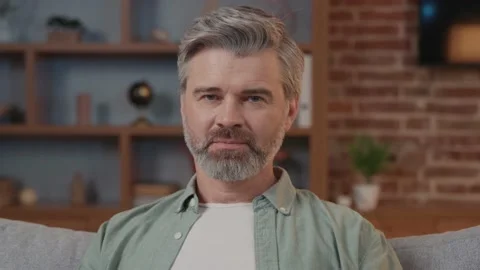 Portrait of handsome man taking off his glasses and smiling looking at camera Vídeos de archivo 220201889