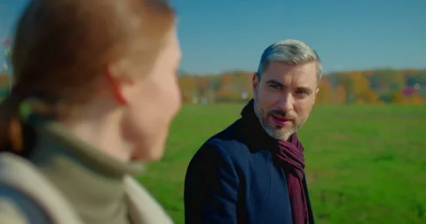 Portrait of handsome man talking with his pretty wife while they walking down Vídeo Stock 246737885