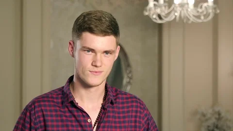 Portrait handsome man unbuttoning checkered shirt and looking in camera Stock-Footage 83666531