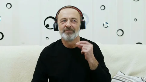 Portrait of handsome middle aged man dance and enjoys music in wireless Stock Footage 124619180