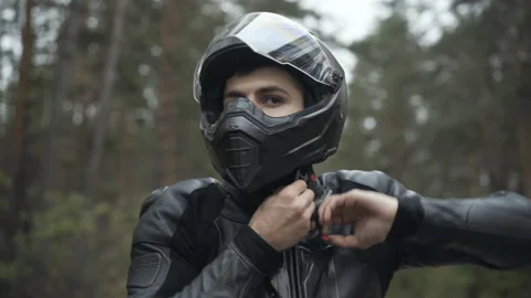 Portrait of handsome Middle Eastern man putting on motorcycle helmet and leather Video stock 144394776