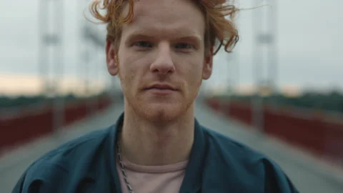 Portrait of handsome red haired man in stylish wear walking outdoors. Close up Video stock 162617793