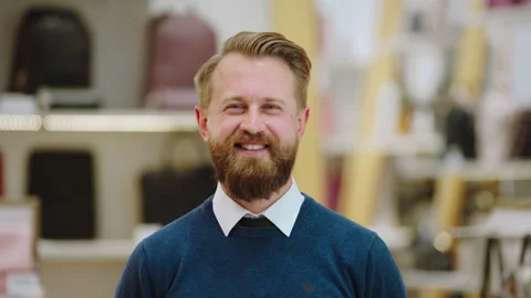 Portrait of a handsome salesman posing in front of the camera smiling large in Stock Footage 169866958