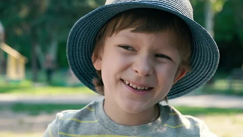Portrait of a handsome smiling boy looking at the camera in a hat Stock Footage 134982067