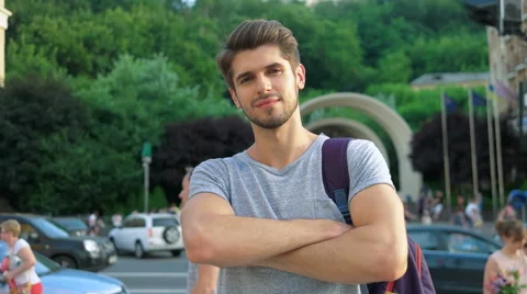 Portrait of a handsome smiling man looking at the camera in city Stock Footage 68599413