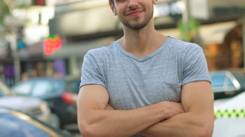 Portrait of a handsome smiling man looking at the camera in city Stock Footage 68599483